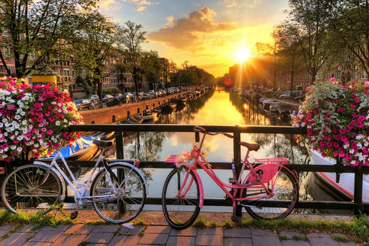 a couple of bicycles parked on a bridge over a river